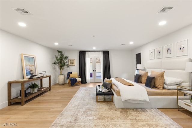 bedroom featuring access to exterior, french doors, and light hardwood / wood-style floors