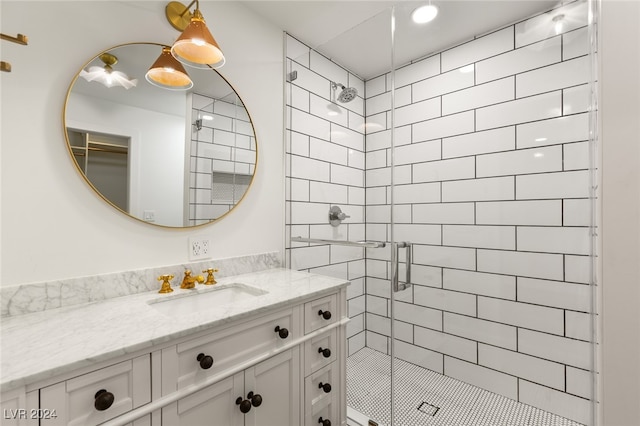 bathroom with walk in shower and vanity