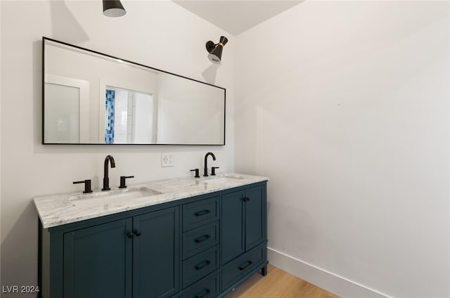 bathroom with vanity and hardwood / wood-style flooring