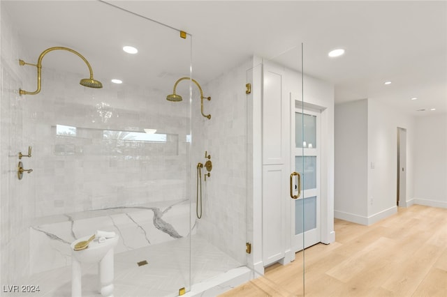 bathroom with walk in shower and wood-type flooring