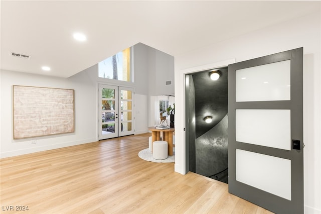 hall featuring light hardwood / wood-style floors and french doors