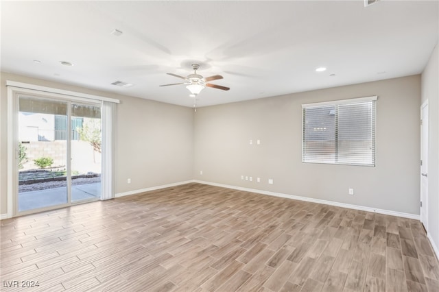 spare room with light wood-type flooring and ceiling fan