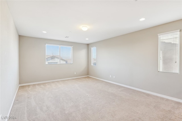 spare room with light colored carpet