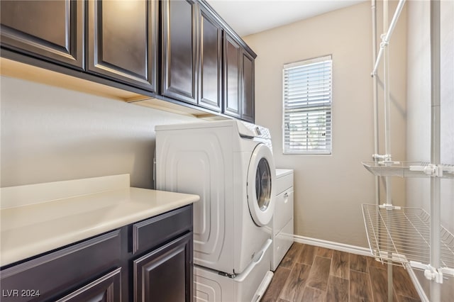 laundry room featuring dark wood-type flooring, cabinets, and independent washer and dryer