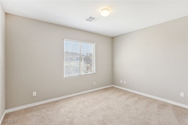 unfurnished room with light carpet