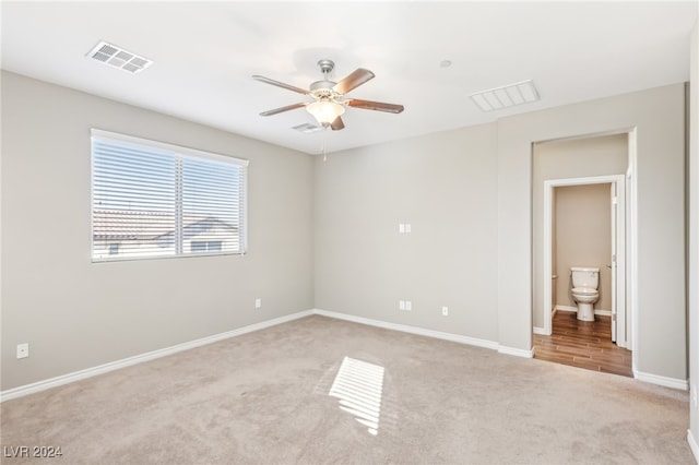 empty room with ceiling fan and light colored carpet