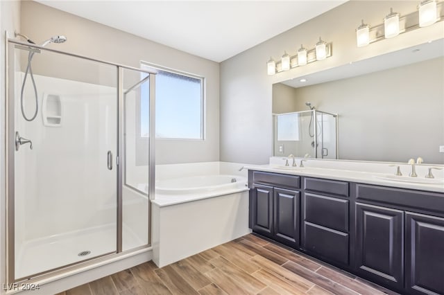 bathroom featuring vanity, shower with separate bathtub, and wood-type flooring