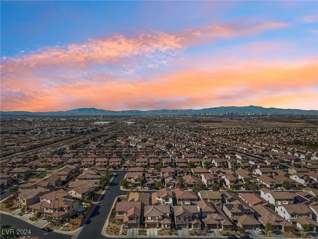 aerial view at dusk featuring a mountain view