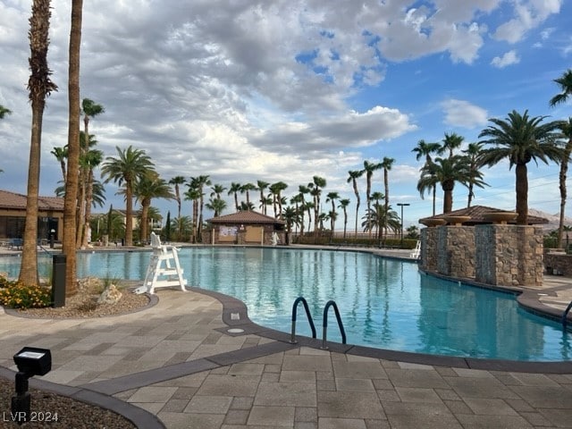 view of swimming pool featuring pool water feature and a patio area