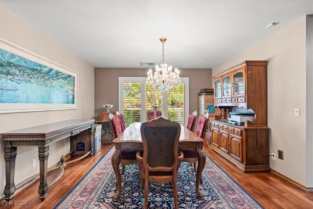 dining room featuring wood-type flooring and a notable chandelier