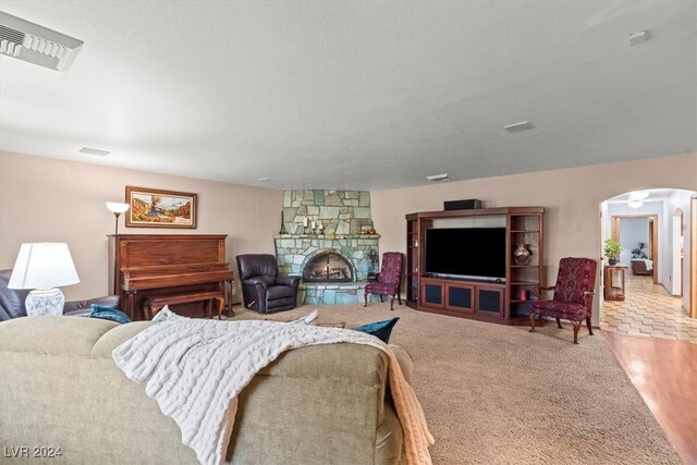 living room featuring light wood-type flooring and a fireplace