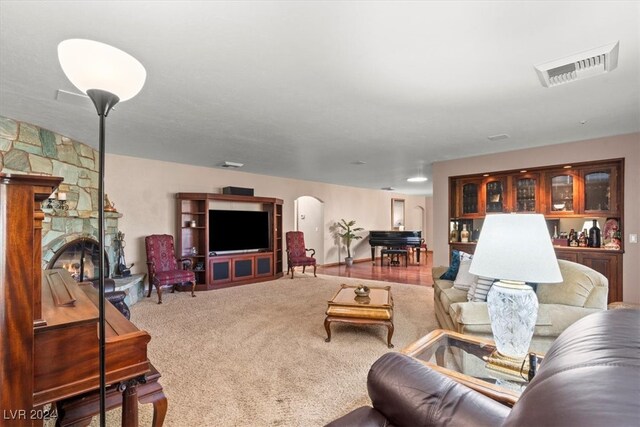 carpeted living room featuring a fireplace