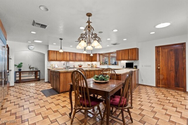 dining space with a chandelier and sink