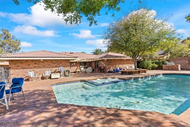 view of pool featuring an in ground hot tub and a patio area