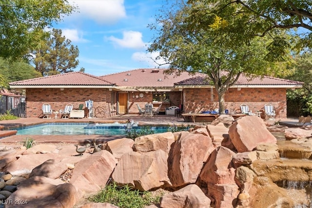 view of pool with pool water feature and a patio area