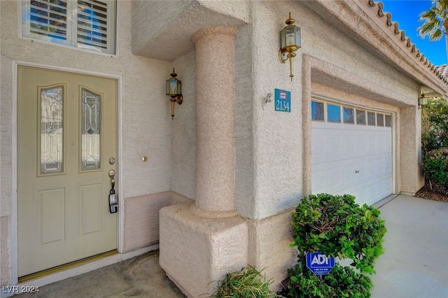 view of exterior entry featuring a garage