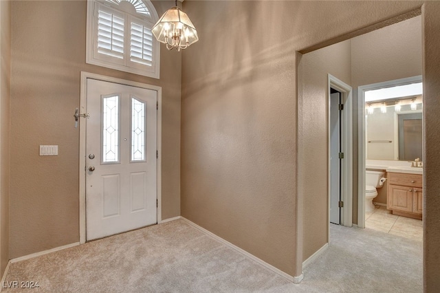 carpeted foyer entrance featuring a chandelier and sink