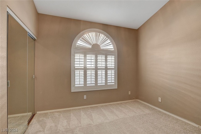 spare room with light colored carpet