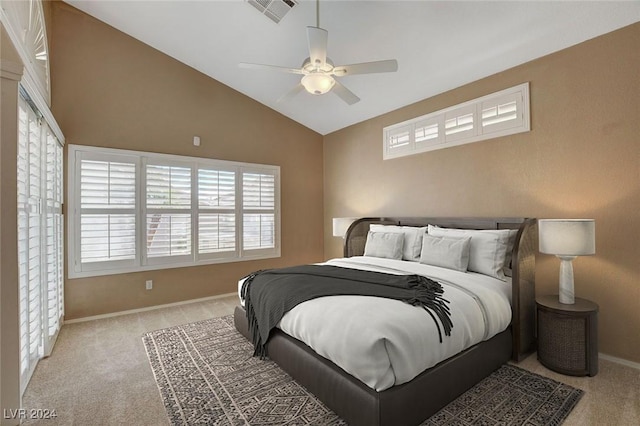 bedroom featuring ceiling fan, lofted ceiling, and light carpet