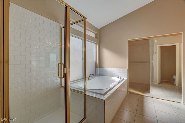 bathroom with tile patterned flooring, separate shower and tub, lofted ceiling, and toilet