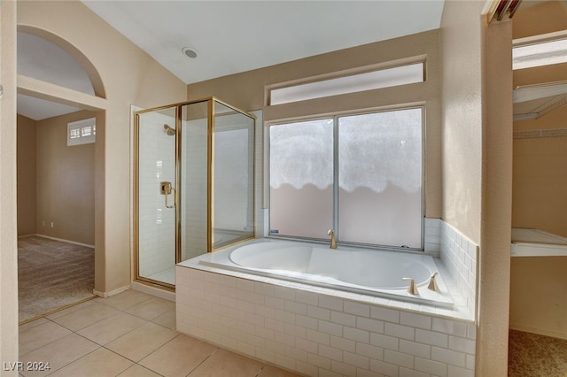 bathroom featuring tile patterned flooring and shower with separate bathtub