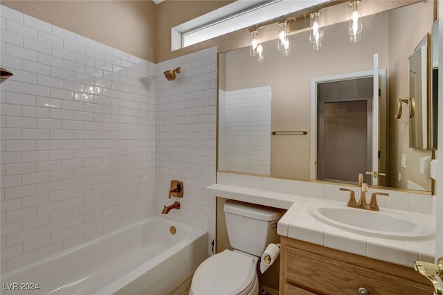 full bathroom featuring vanity, toilet, and tiled shower / bath