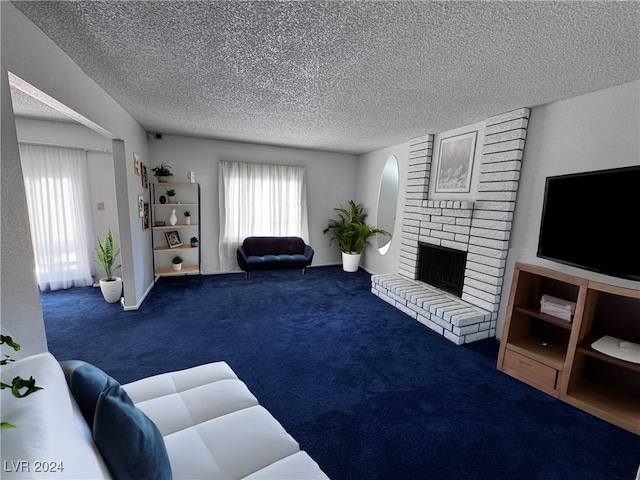 carpeted living room with a brick fireplace and a textured ceiling