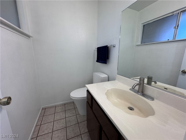 bathroom with tile patterned flooring, vanity, and toilet