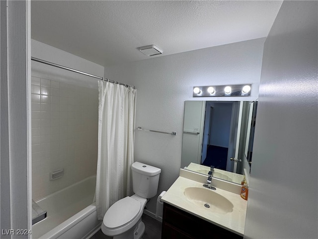 full bathroom with toilet, shower / tub combo with curtain, vanity, and a textured ceiling