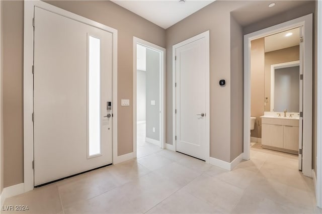 tiled entrance foyer with sink