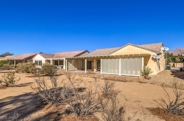 single story home with central AC unit and a garage