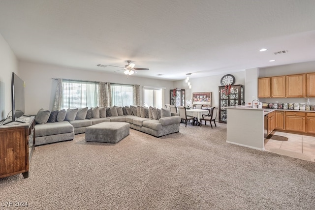 carpeted living room with a textured ceiling and ceiling fan