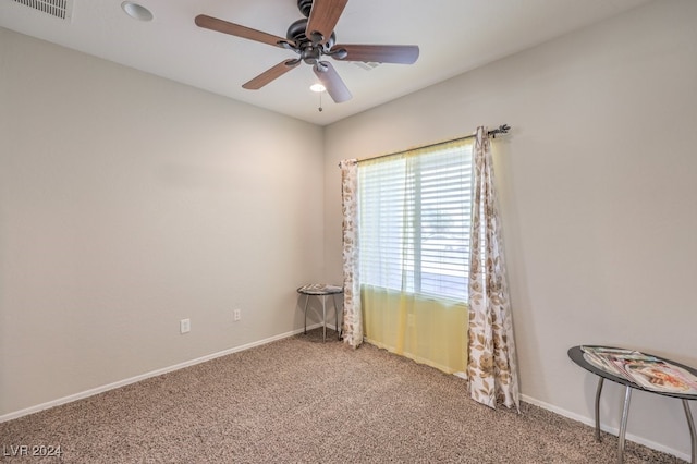 carpeted spare room featuring ceiling fan