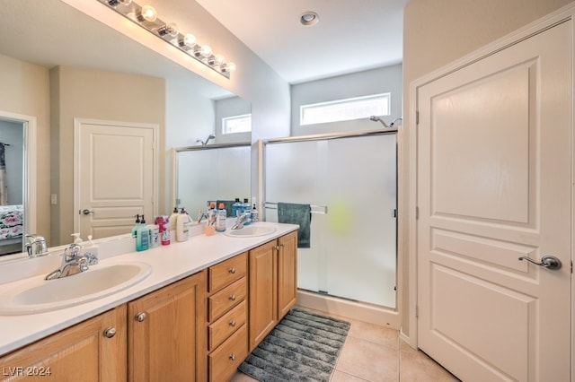 bathroom featuring vanity, a shower with shower door, and tile patterned flooring