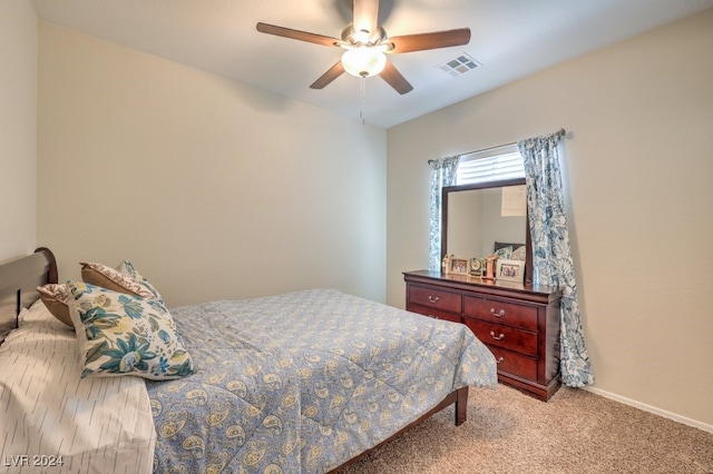 bedroom with ceiling fan and light carpet