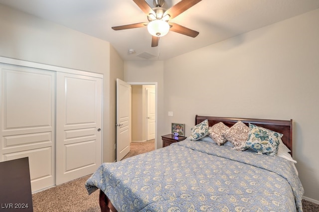 carpeted bedroom featuring ceiling fan and a closet