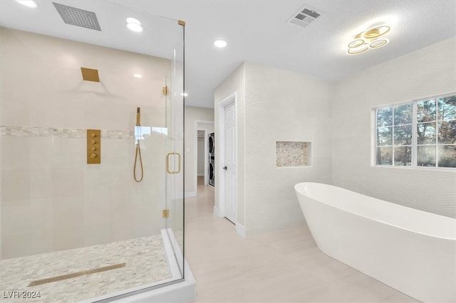 bathroom featuring recessed lighting, a freestanding tub, visible vents, and a shower stall