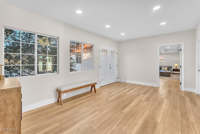 entryway with baseboards, light wood-style flooring, and recessed lighting