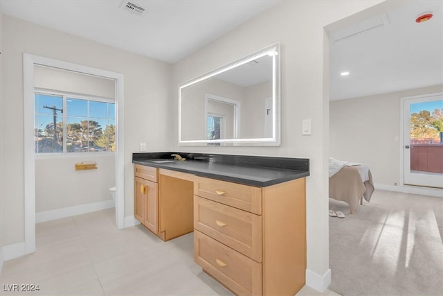 bathroom featuring baseboards, visible vents, toilet, ensuite bathroom, and vanity