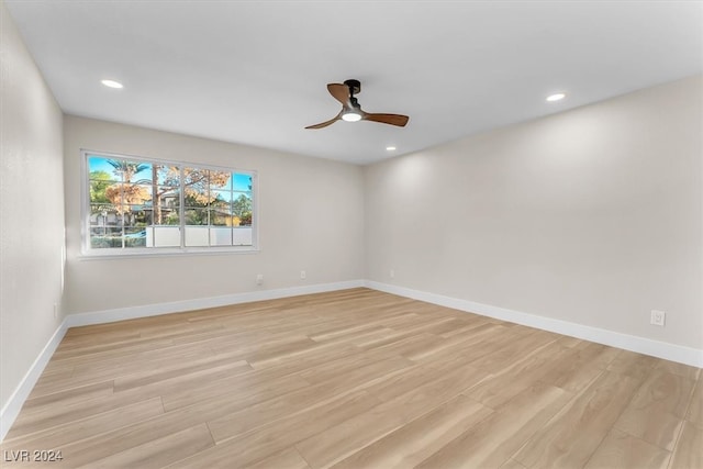 unfurnished room with light wood finished floors, recessed lighting, and baseboards