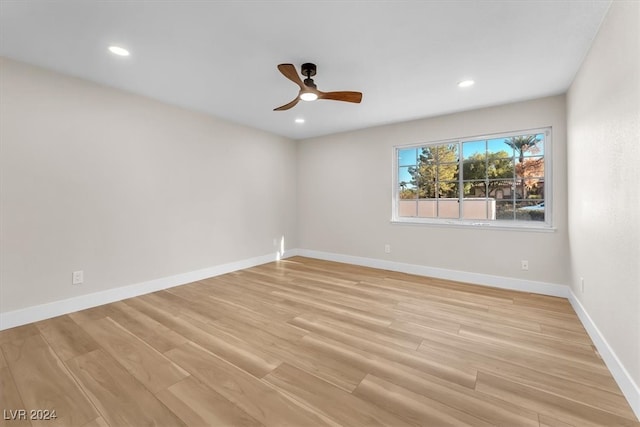 spare room featuring light wood-style floors, baseboards, a ceiling fan, and recessed lighting