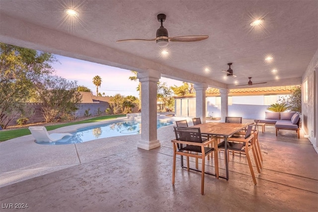 view of patio / terrace featuring a fenced in pool, outdoor dining area, a fenced backyard, and ceiling fan