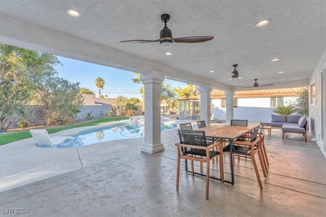 view of patio / terrace with a fenced backyard, outdoor dining area, and a fenced in pool