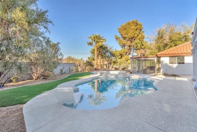 outdoor pool with a yard, a fenced backyard, and a patio