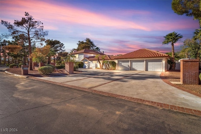 mediterranean / spanish house with concrete driveway and stucco siding