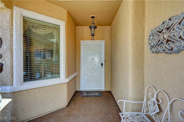 property entrance featuring stucco siding