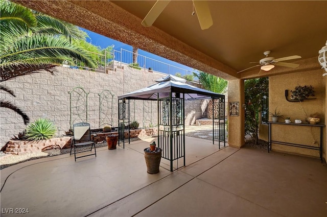 view of patio featuring ceiling fan and fence