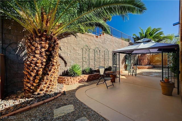 view of patio featuring a fenced backyard and a gazebo