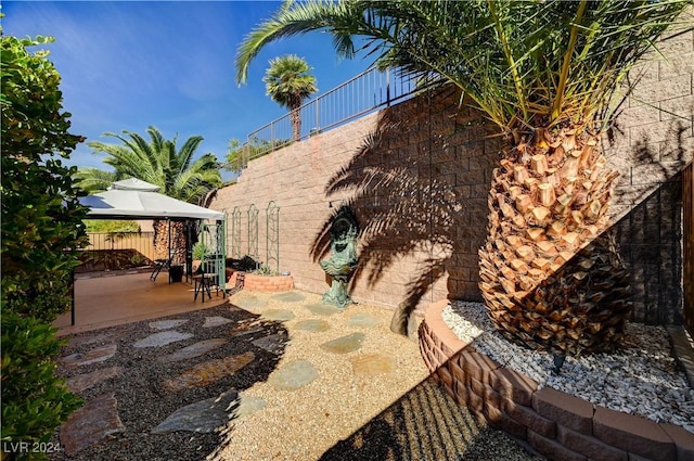 view of yard with a gazebo, a patio, and fence