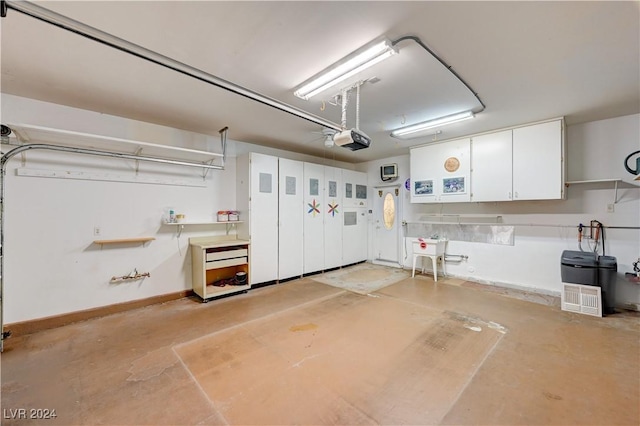 garage with baseboards and a garage door opener